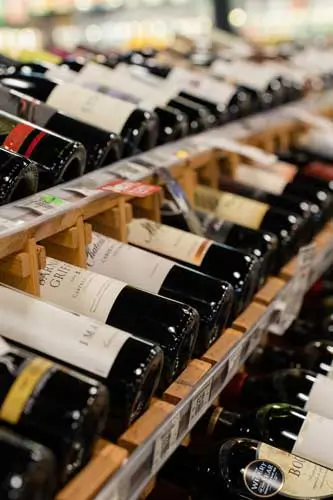 Wine-333x500-1 Wine shelf stocked with a wide variety of bottles